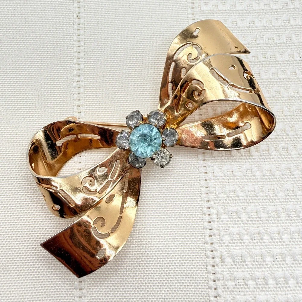 Vintage CORO Gray and Blue Rhinestones Gold Tone Cutout Bow Pin Brooch